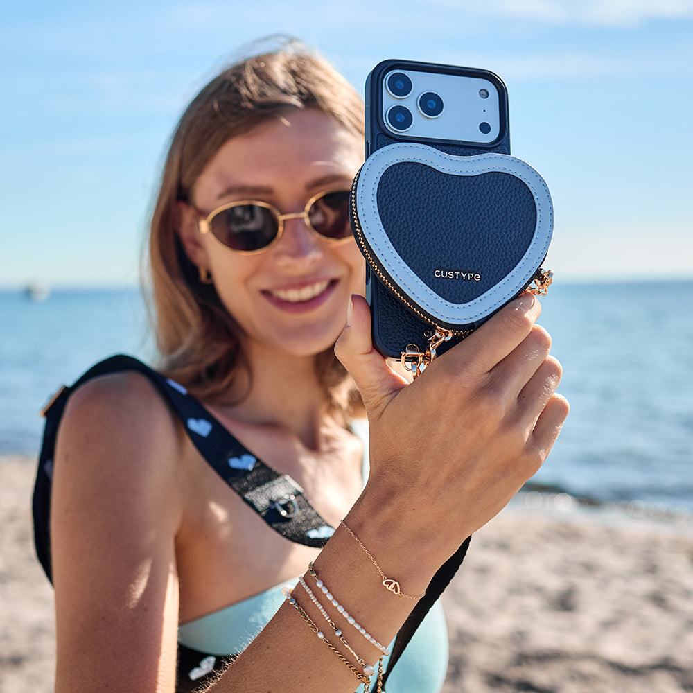 Woman holding MagSafe crossbody phone case with card holder