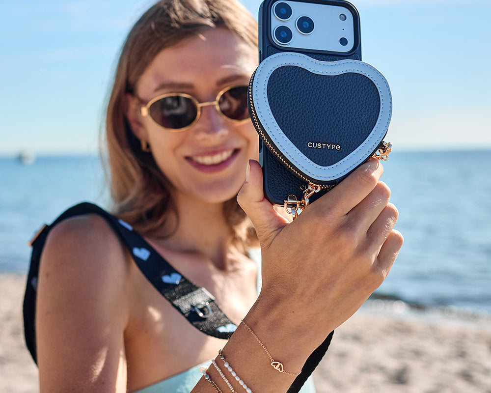 Woman holding MagSafe crossbody phone case with card holder