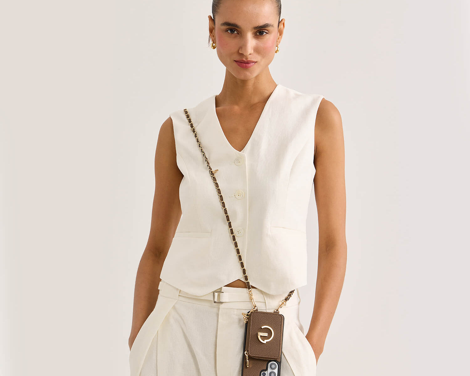person wearing a crossbody phone case with an adjustable chain and magnetic card wallet