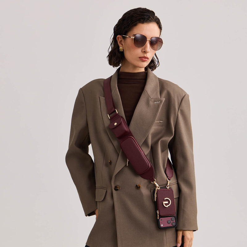 Model wearing a burgundy Custype crossbody phone case with wallet and accessory pouches