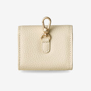 Elegant beige AirPods case pouch featuring premium leather finish and minimalist design