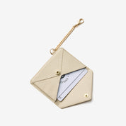 Beige envelope-inspired detachable wallet with leather finish and gold-tone chain clip for everyday essentials