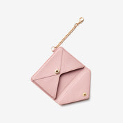 Compact pink wallet accessory featuring leather texture and elegant chain clip for daily carry