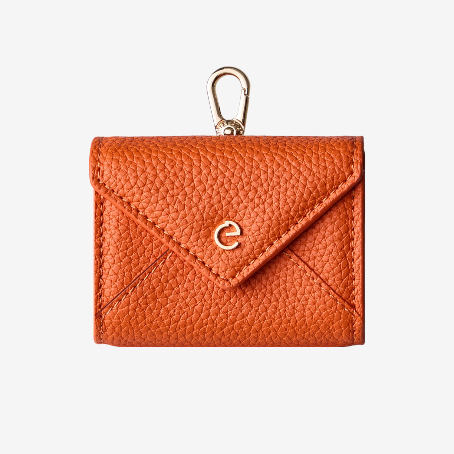Orange envelope-inspired AirPods pouch with leather finish and gold-tone clip for everyday carry