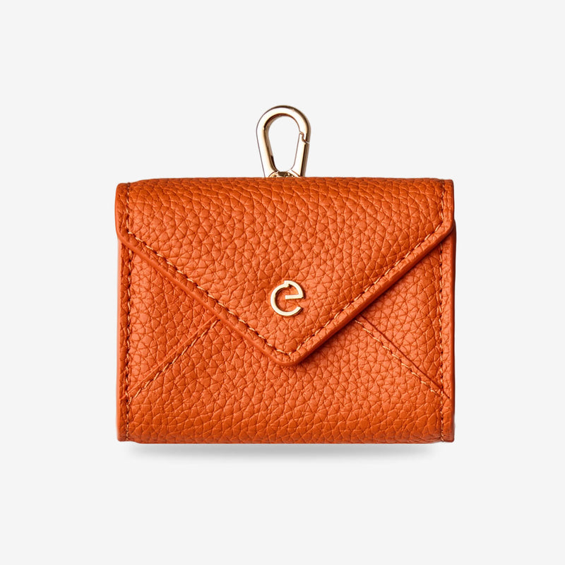 Orange envelope-inspired AirPods pouch with leather finish and gold-tone clip for everyday carry