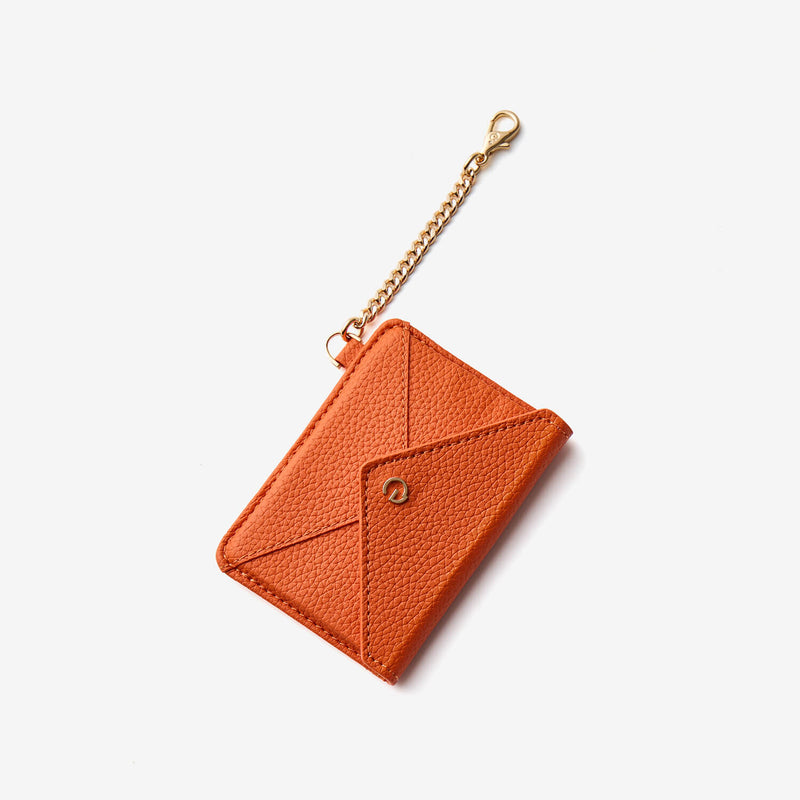 Orange envelope card holder with detachable clip attachment for convenient daily carry