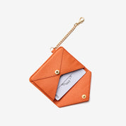 Orange envelope-inspired card wallet designed for carrying cards during daily activities and outings
