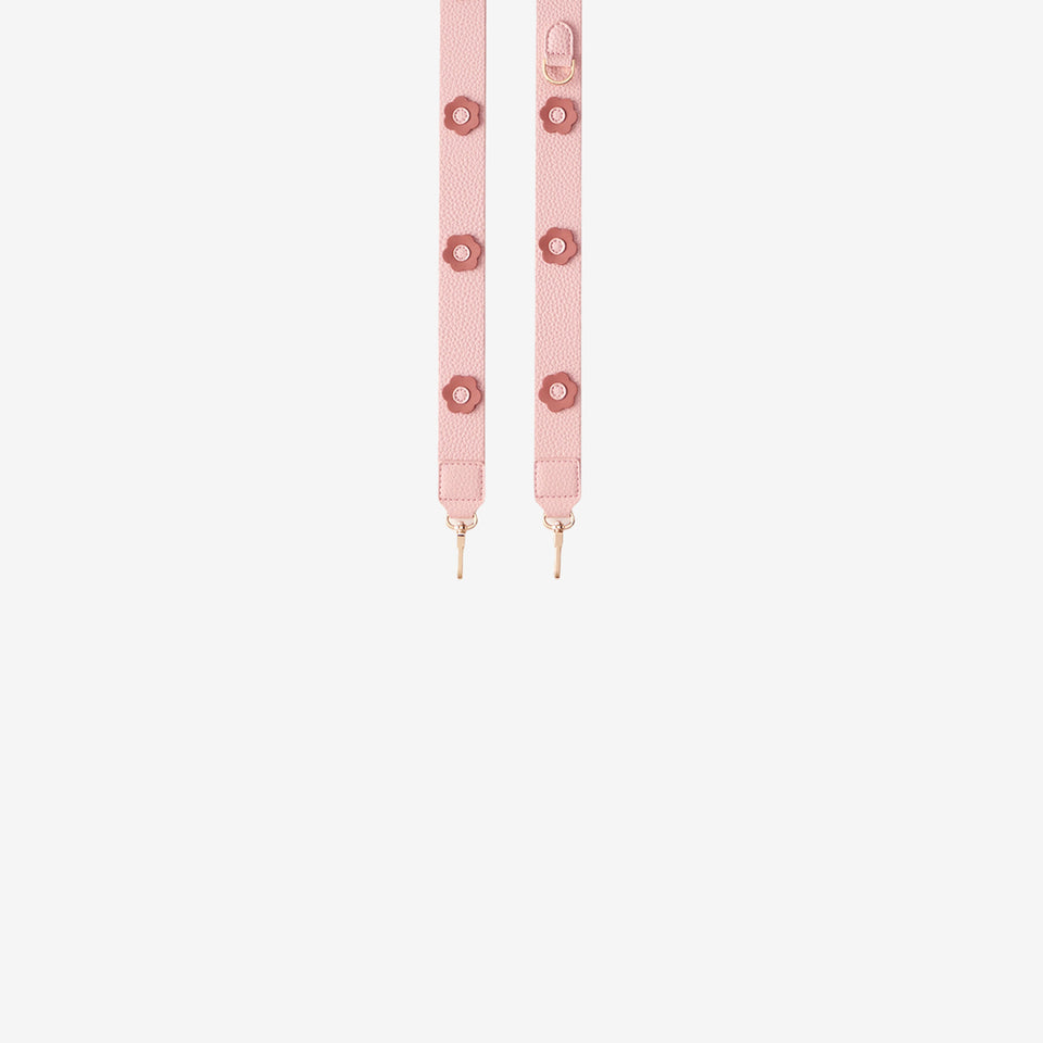 Pink strap with gold hardware on a white background