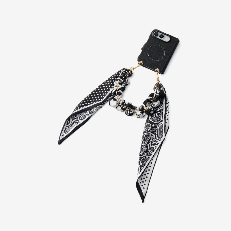 Black iPhone DUO case featuring a decorative silk scarf strap and elegant leather texture for daily outings
