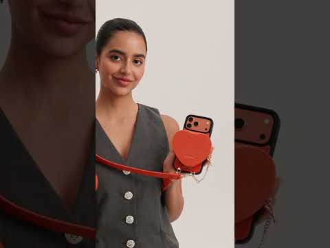 Orange iPhone 17 Pro Max leather crossbody phone case with cute heart pouch for hands-free