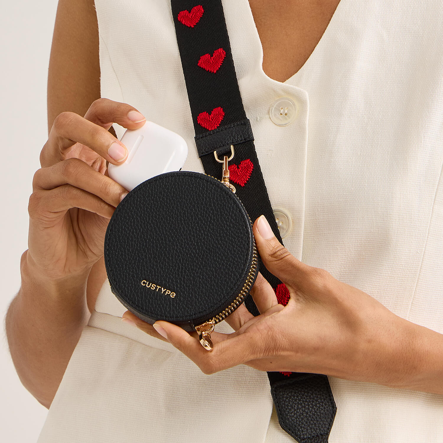 black round pouch with a strap for storage airpdos and travel